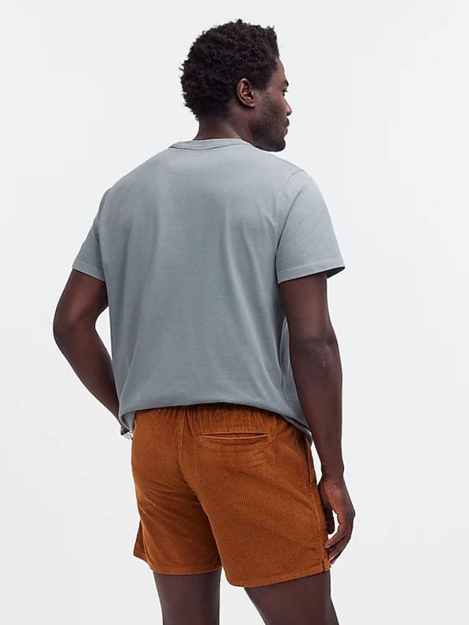 man from behind wearing a grey t-shirt and orange corduroy shorts