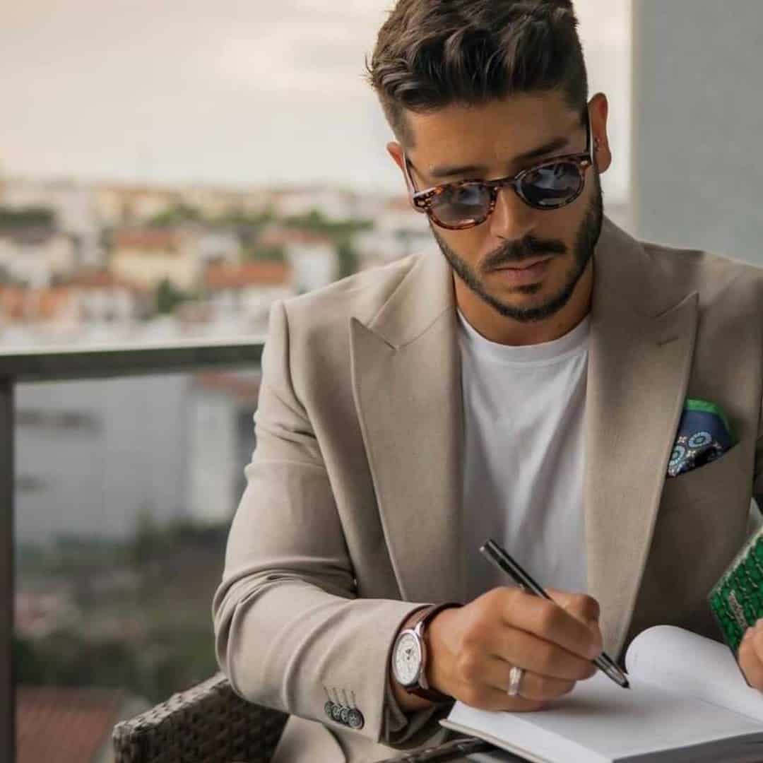 man writing on a journal