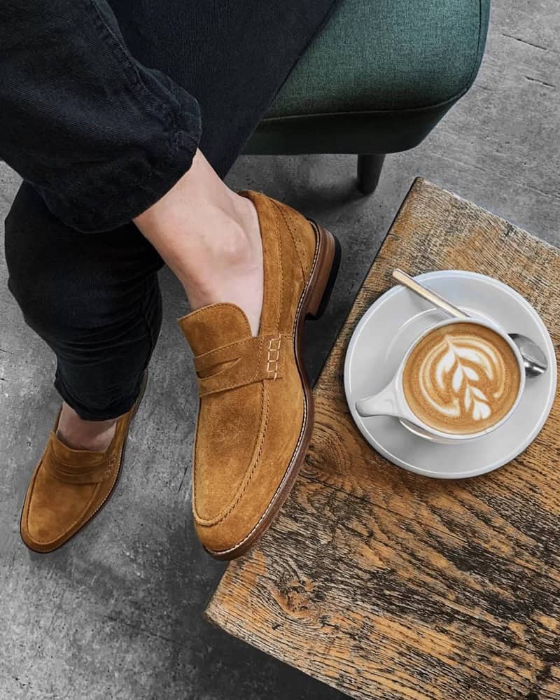 wearing a pair of Brown Suede loafers by clarks