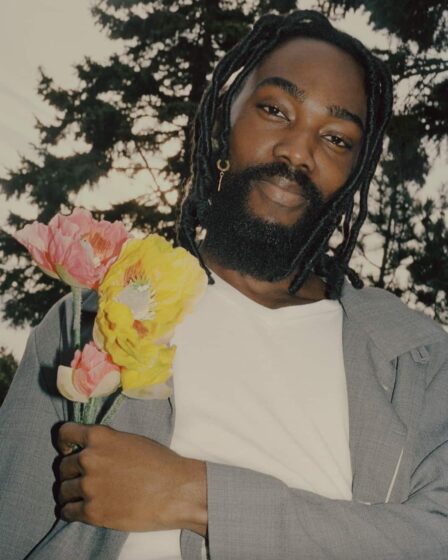 man holding flowers wearing a v neck t-shirt