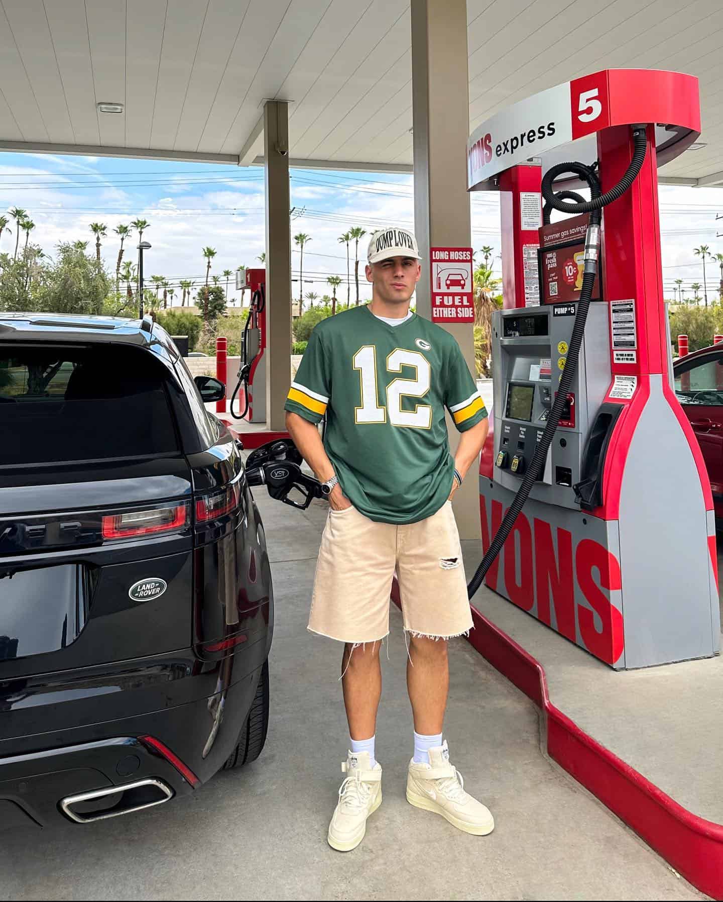 man filling car with fuel