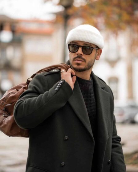 man in a jacket carrying a weekend bag