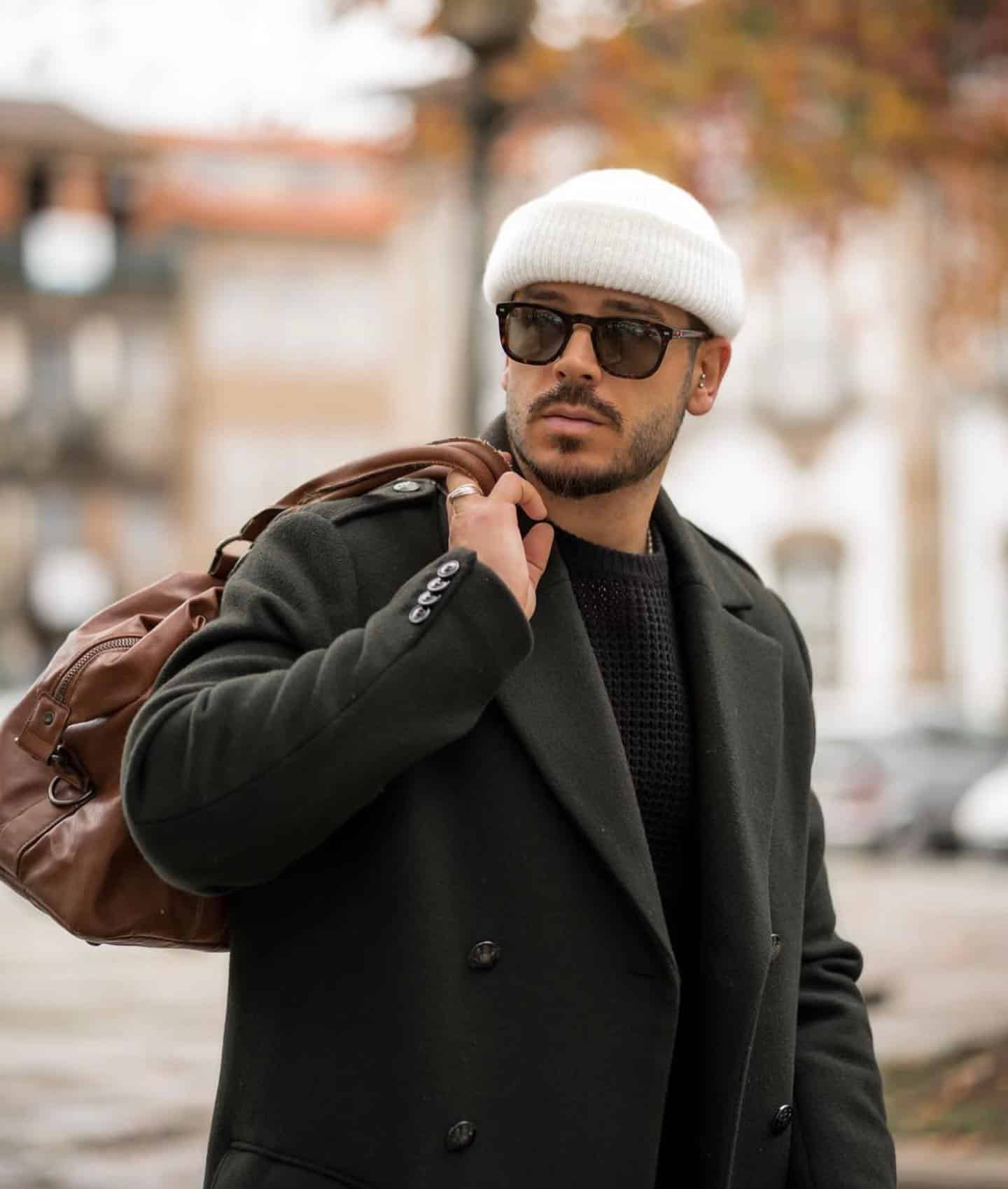 man in a jacket carrying a weekend bag