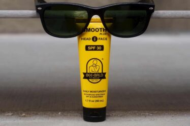 a tube of bee bald daily moisturizer with sunglasses