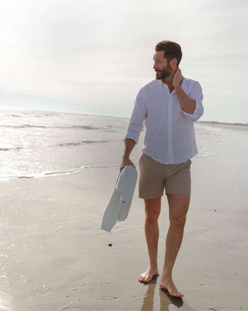 man wearing the billy reid shorts at the beach