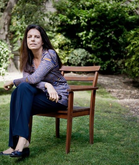 Francoise Bettencourt Meyers sitting in a garden.