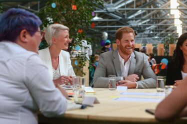 Image may contain Prince Harry Duke of Sussex Meghan Duchess of Sussex Cup Face Happy Head Laughing and Person