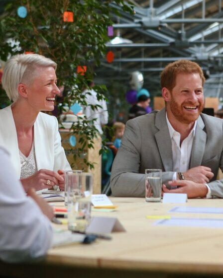 Image may contain Prince Harry Duke of Sussex Meghan Duchess of Sussex Cup Face Happy Head Laughing and Person