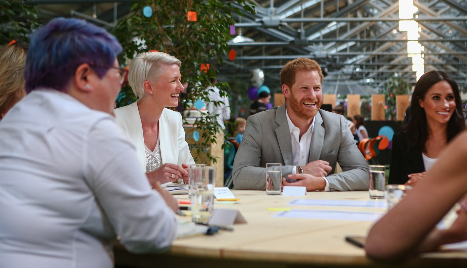 Image may contain Prince Harry Duke of Sussex Meghan Duchess of Sussex Cup Face Happy Head Laughing and Person