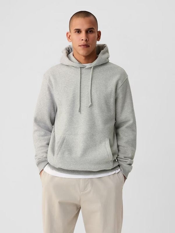 man wearing grey hoodie, white t-shirt and khaki pants