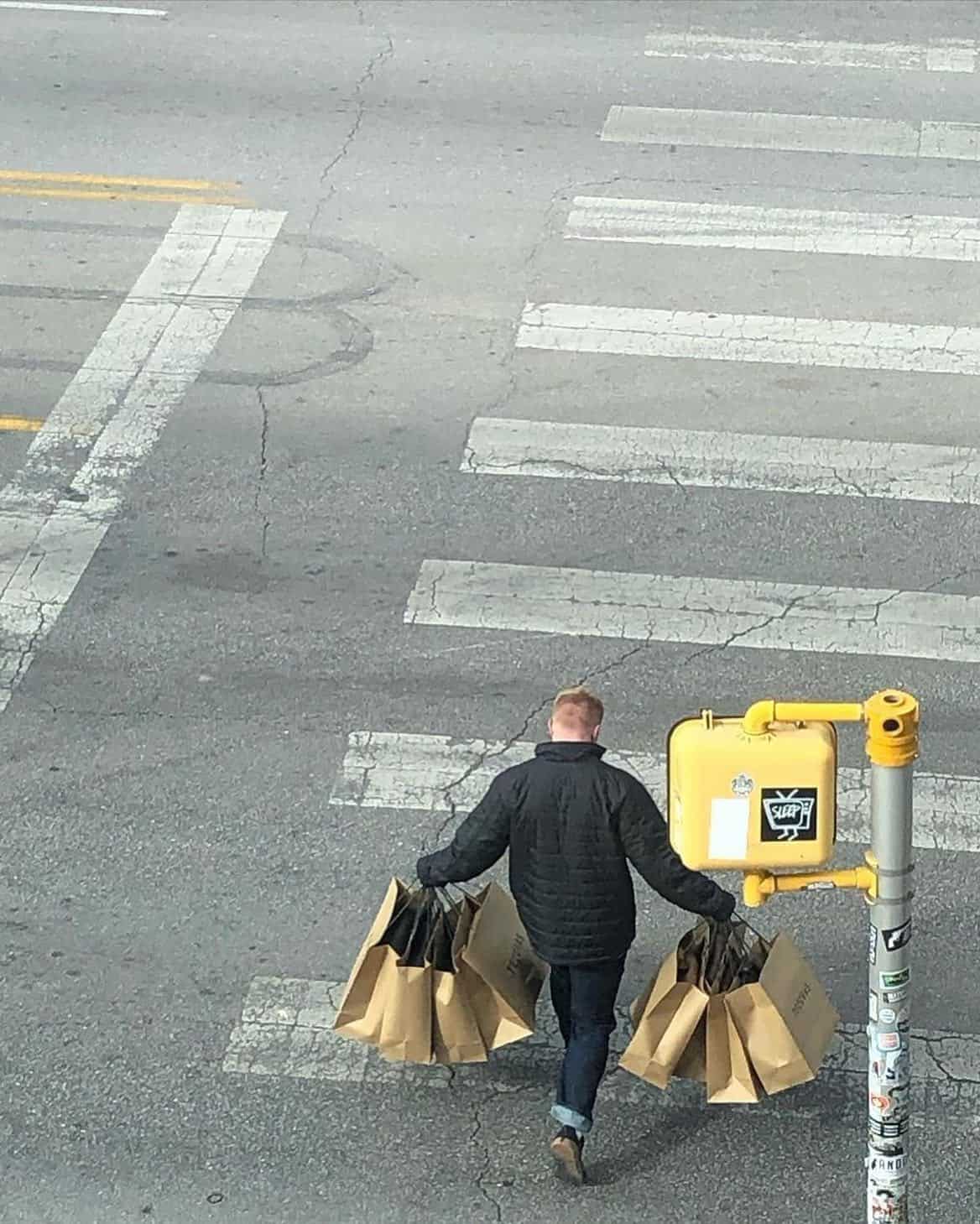 man carrying lots of shopping bags