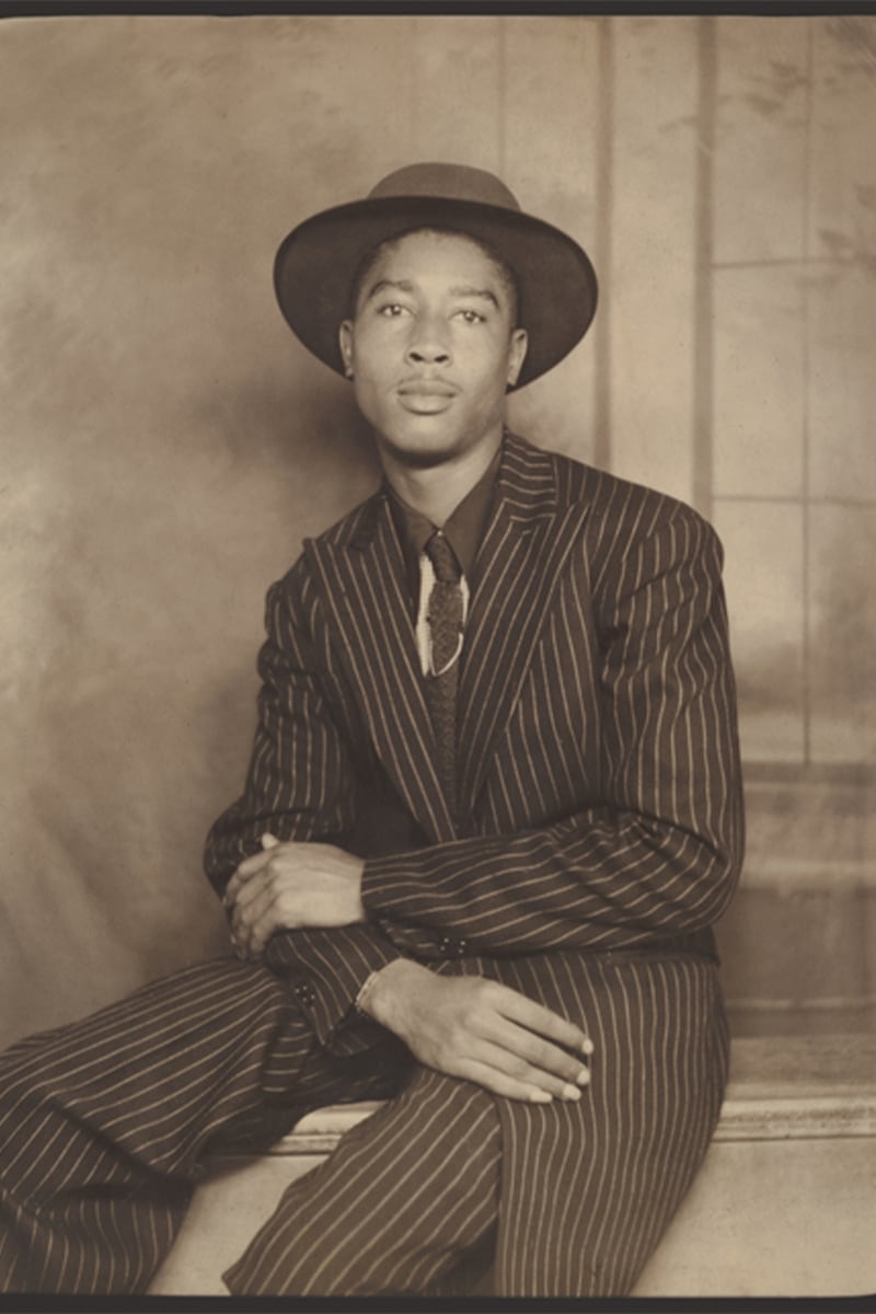 A portrait of a man in a pinstripe suit