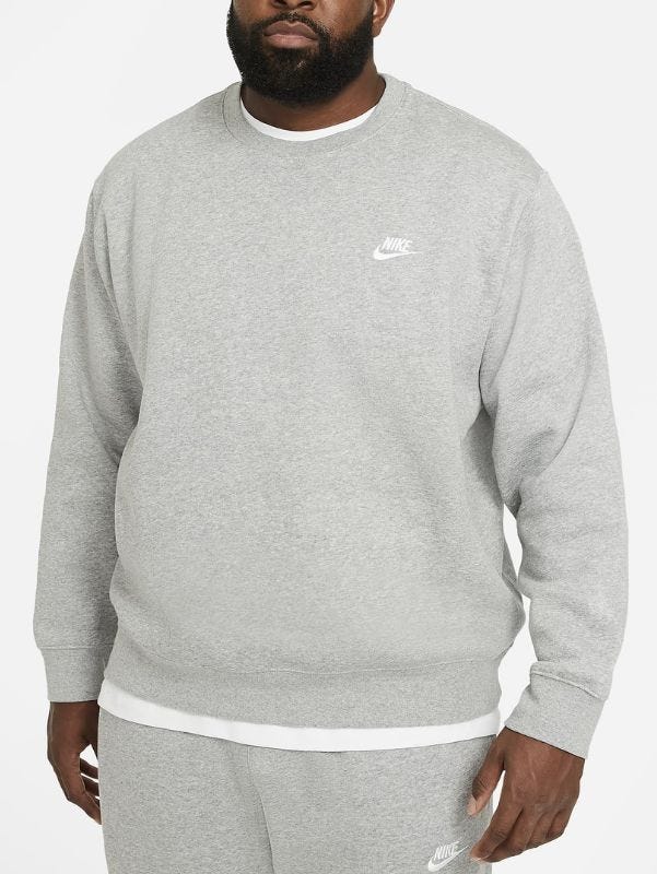 close-up of a man wearing a grey Nike crewneck sweatshirt