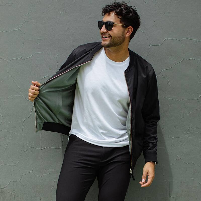 man wearing a White T-shirt under a bomber jacket