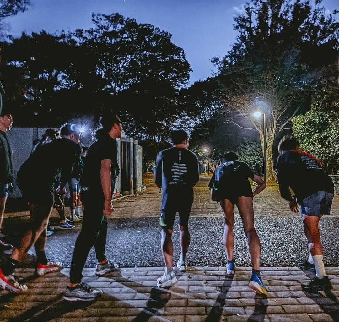 group of runners lining up to begin a run in the pre-morning light