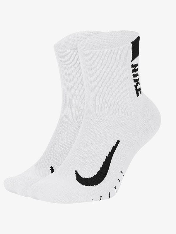 pair of white Nike running socks with a black swoosh on the foot