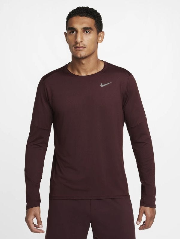 man from the waist up wearing a long-sleeve maroon running shirt