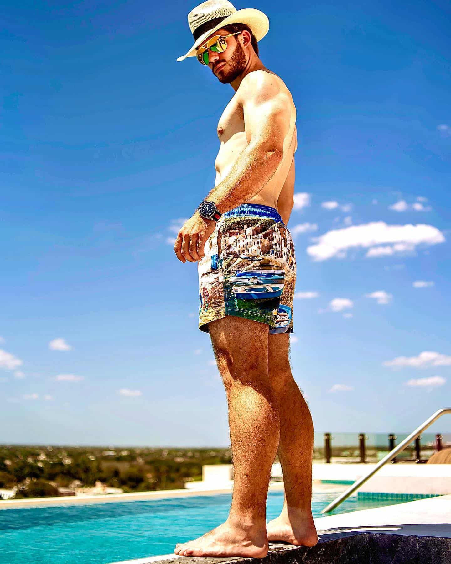 man standing by the pool wearing a printed shorts