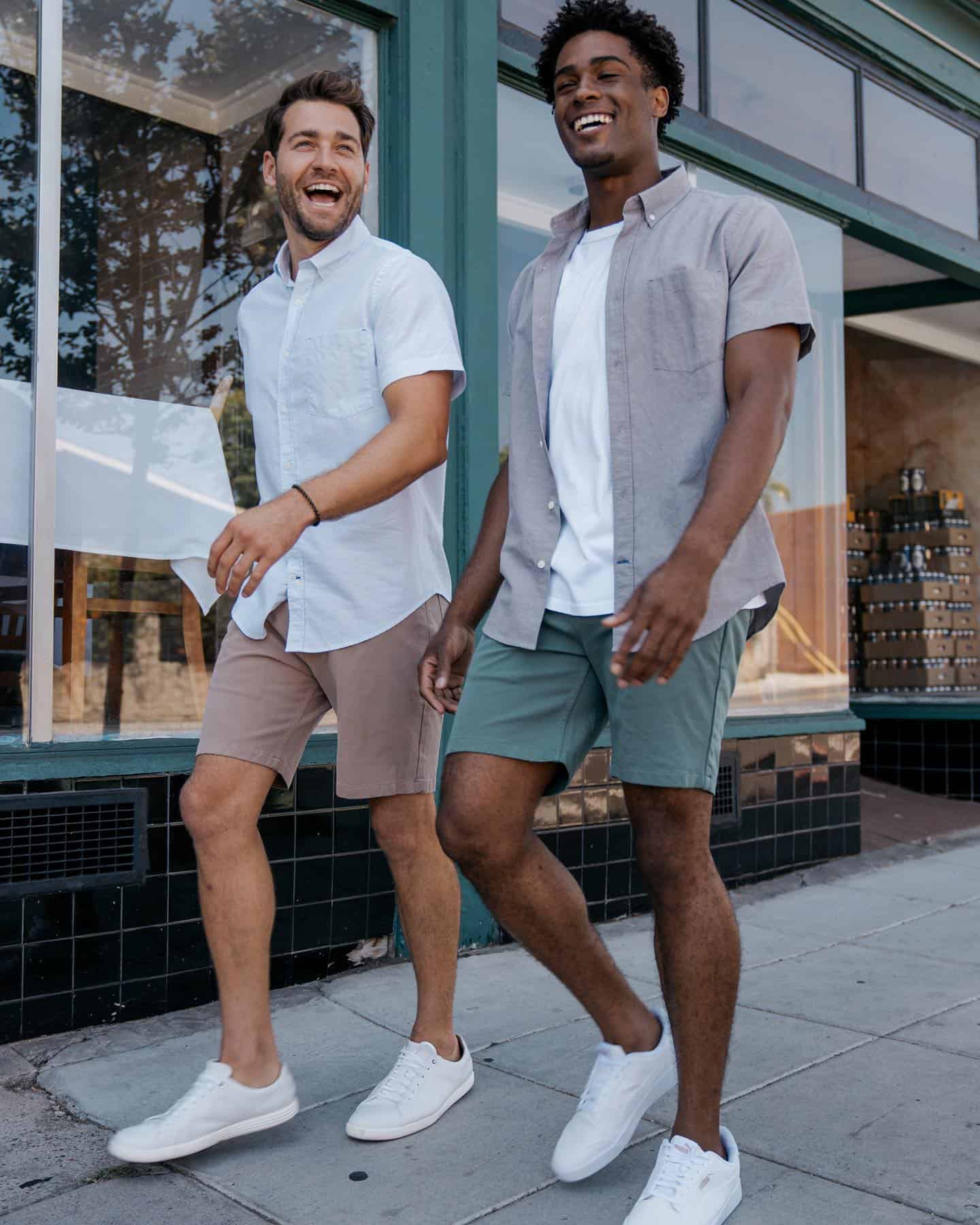 two men happily walking wearing shirts and shorts