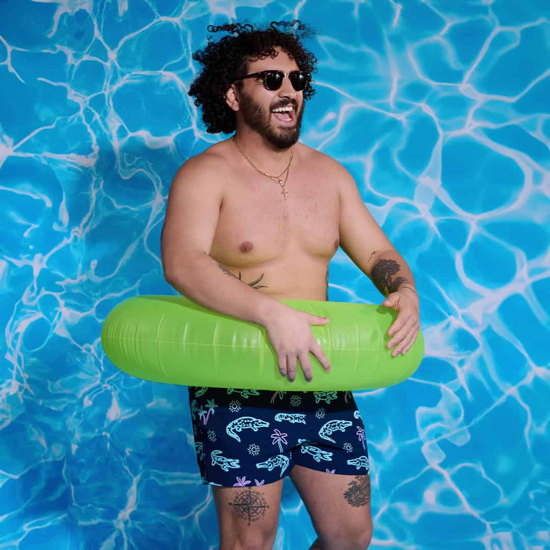 man in a life ring wearing a printed shorts by chubbies