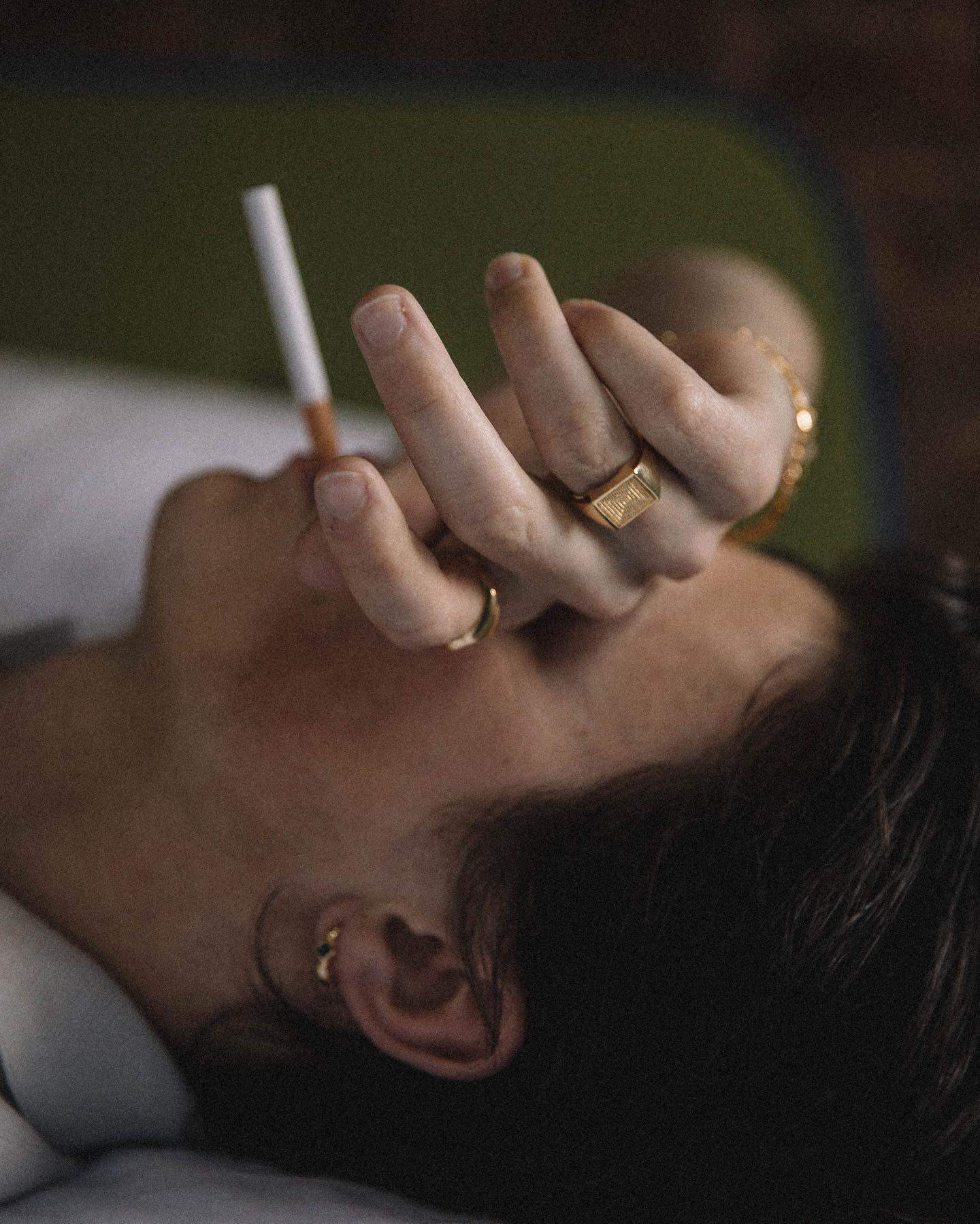 man resting with cigarette on mouth