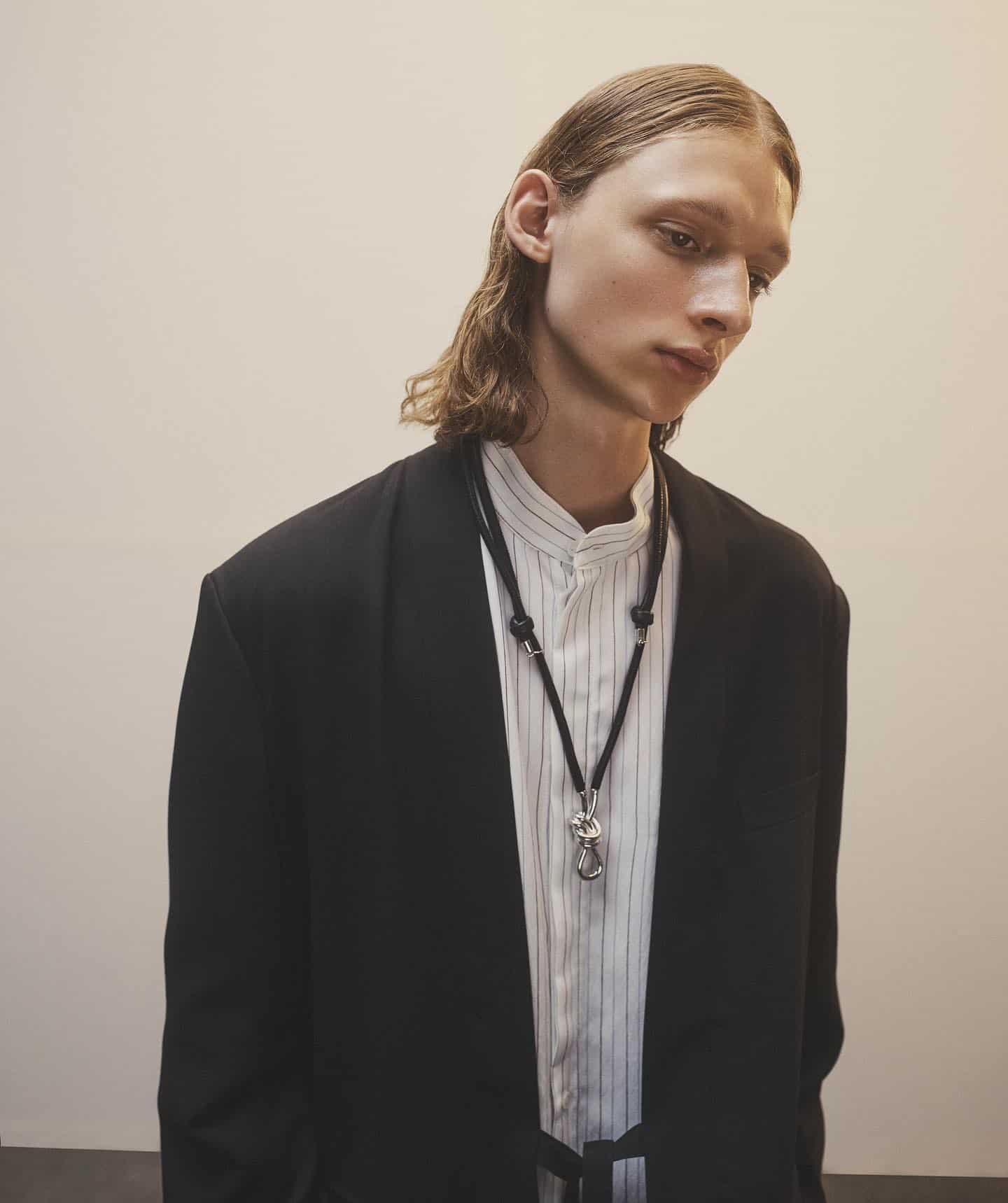 man wearing the knotted leather necklace by ambush