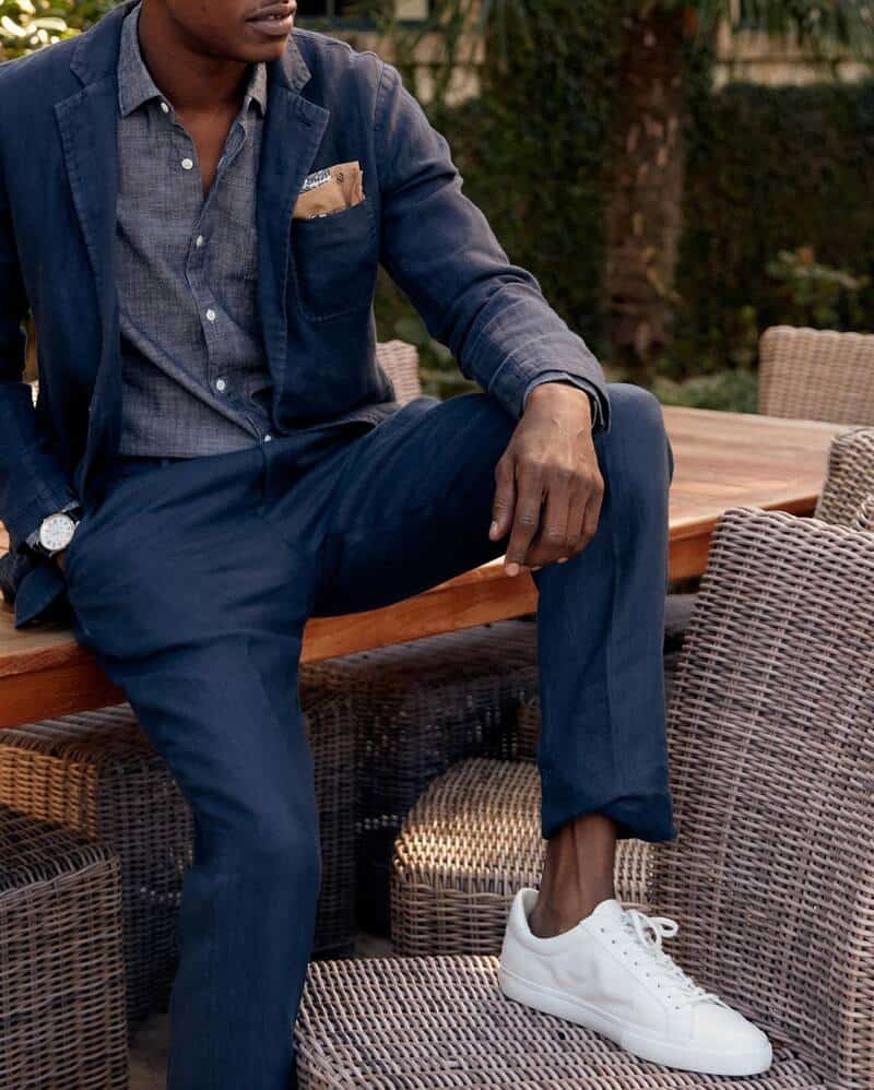 man sitting on the table wearing a blue linen suit by billy reid