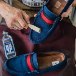 cleaning a suede shoe with a brush