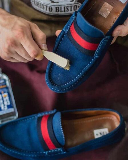 cleaning a suede shoe with a brush