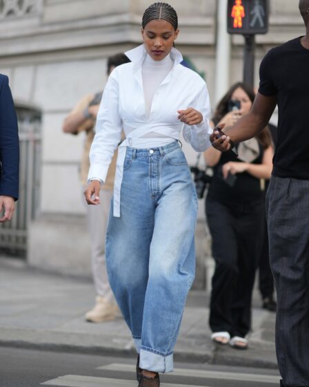 PARIS FRANCE  JULY 02 Tina Kunakey wears gold earrings a white turtleneck long sleeves tshirt a white laces waist...