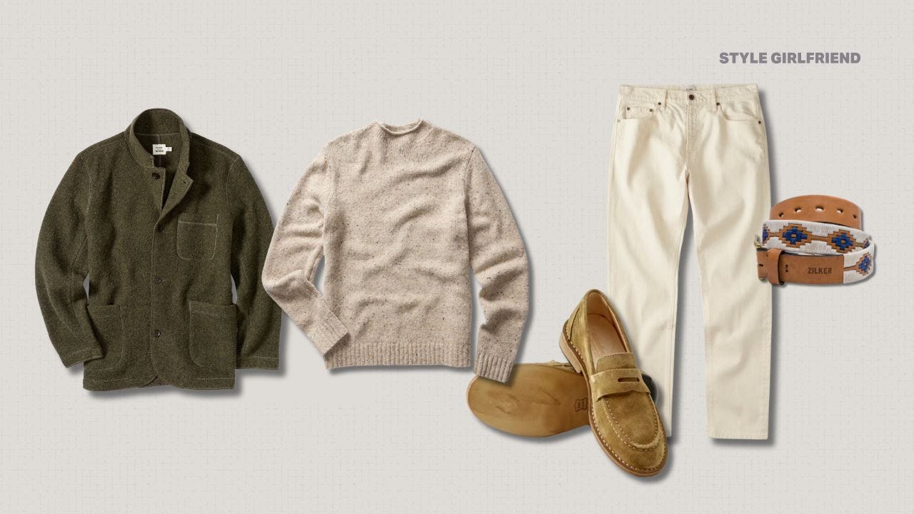 flat lay of a men's outfit with an olive green boiled wool blazer, oatmeal crewneck sweater, tan suede loafers, off-white jeans, and brown belt