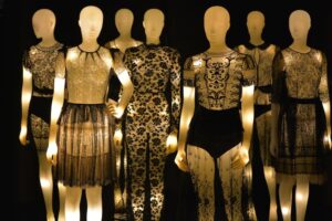 mannequins lit from within display black lace fashion designs