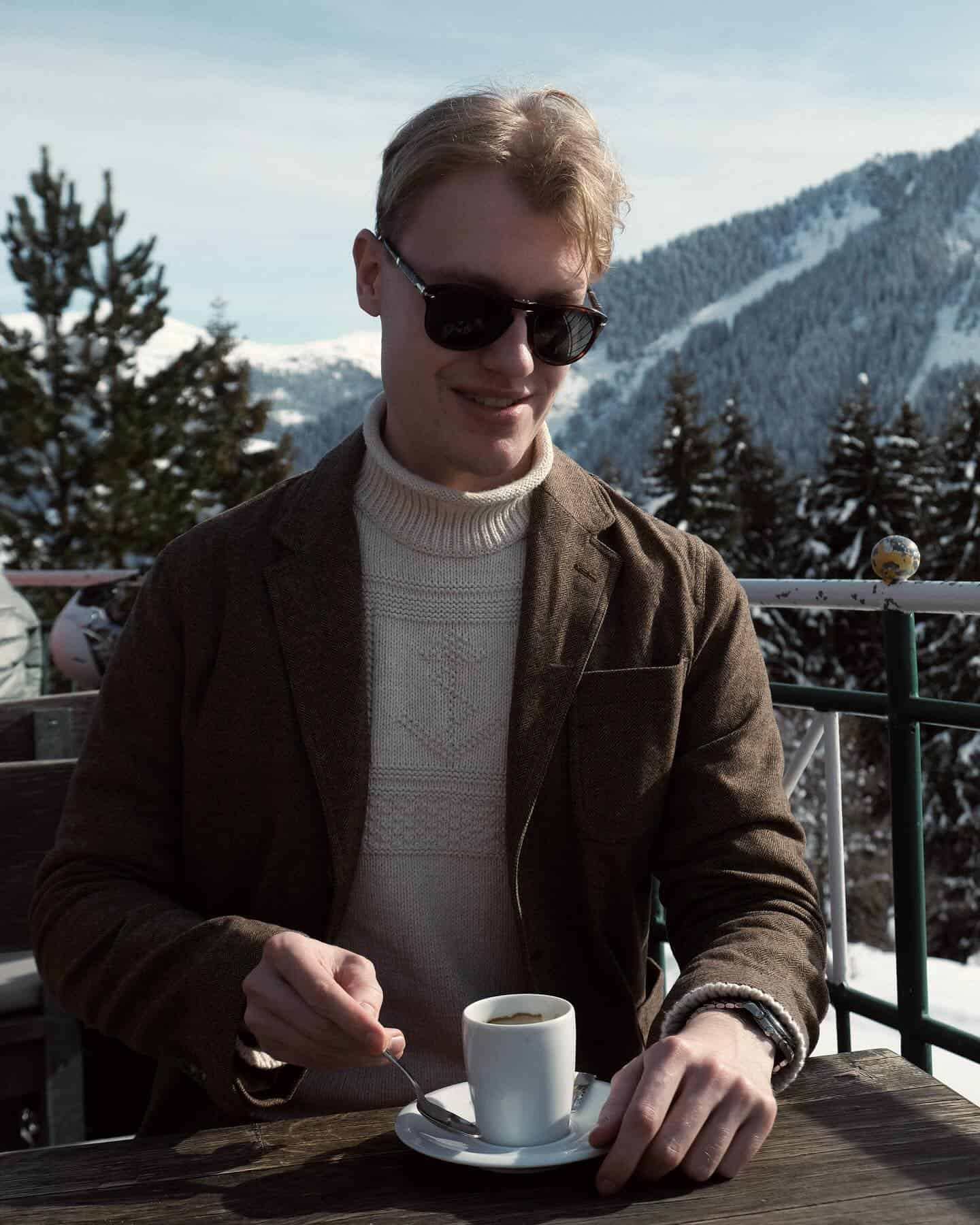 man enjoying a cup of hot drink outdoors