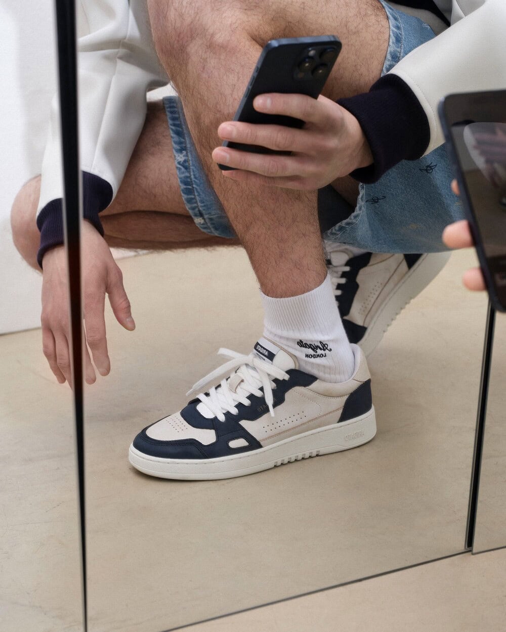 Taking a picture of Dice Lo Sneakers Through a mirror