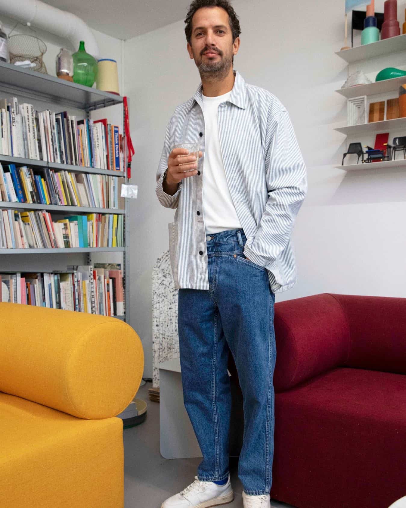 man in a stripped shirt holding a plastic cup