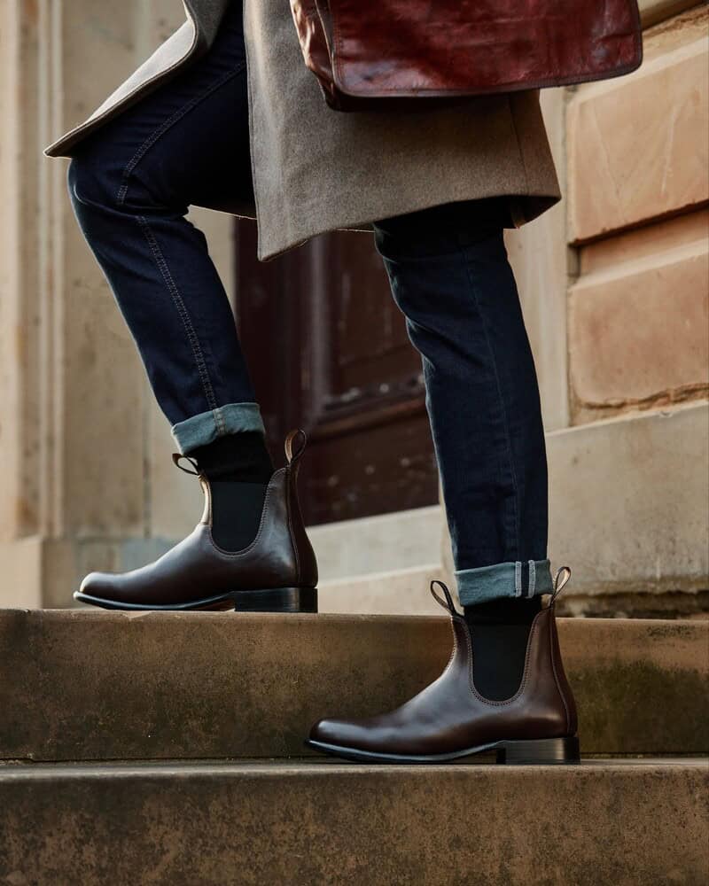 man walking up a stair wearing The Blundstone 155