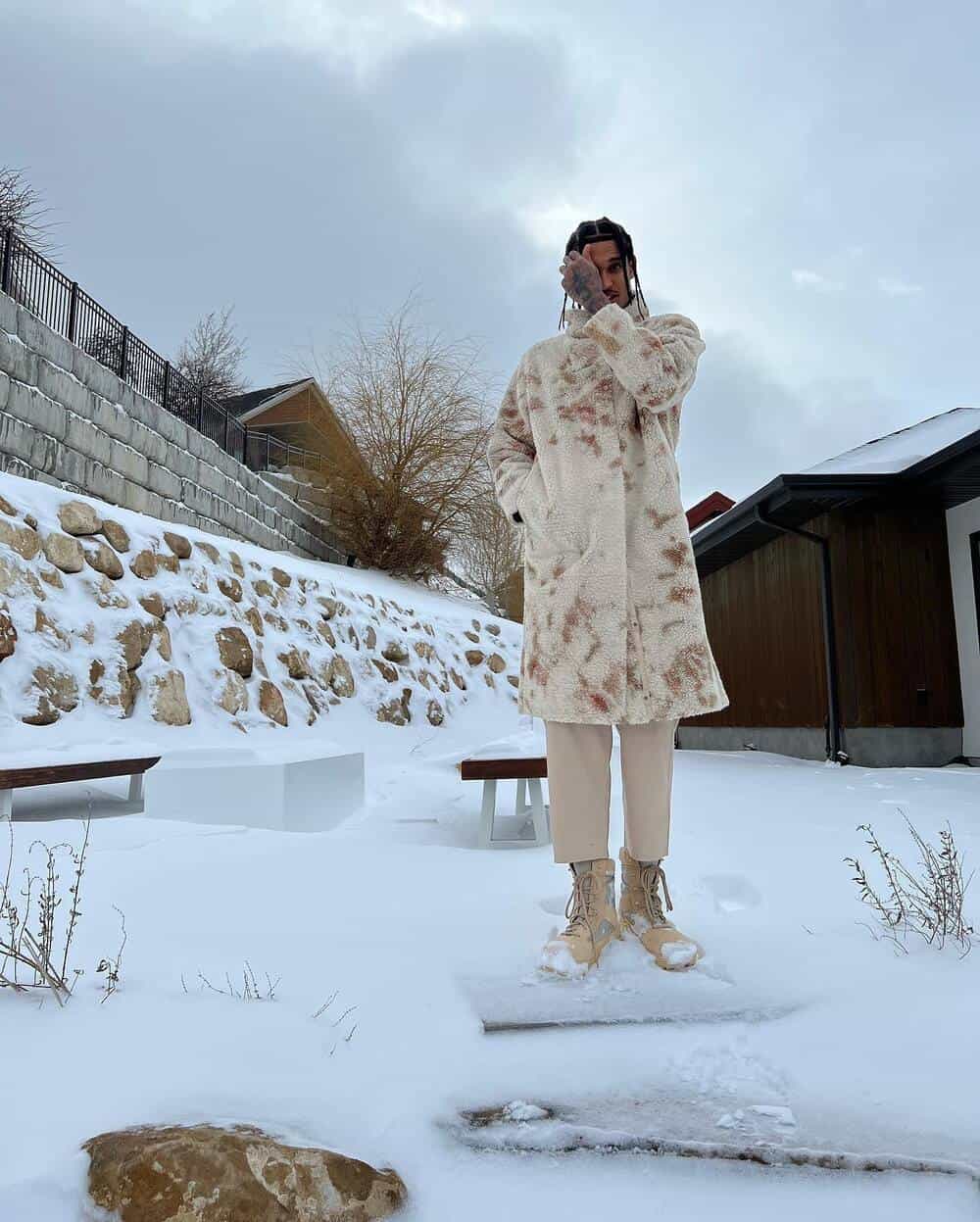 man wearing a wool coat in the snow