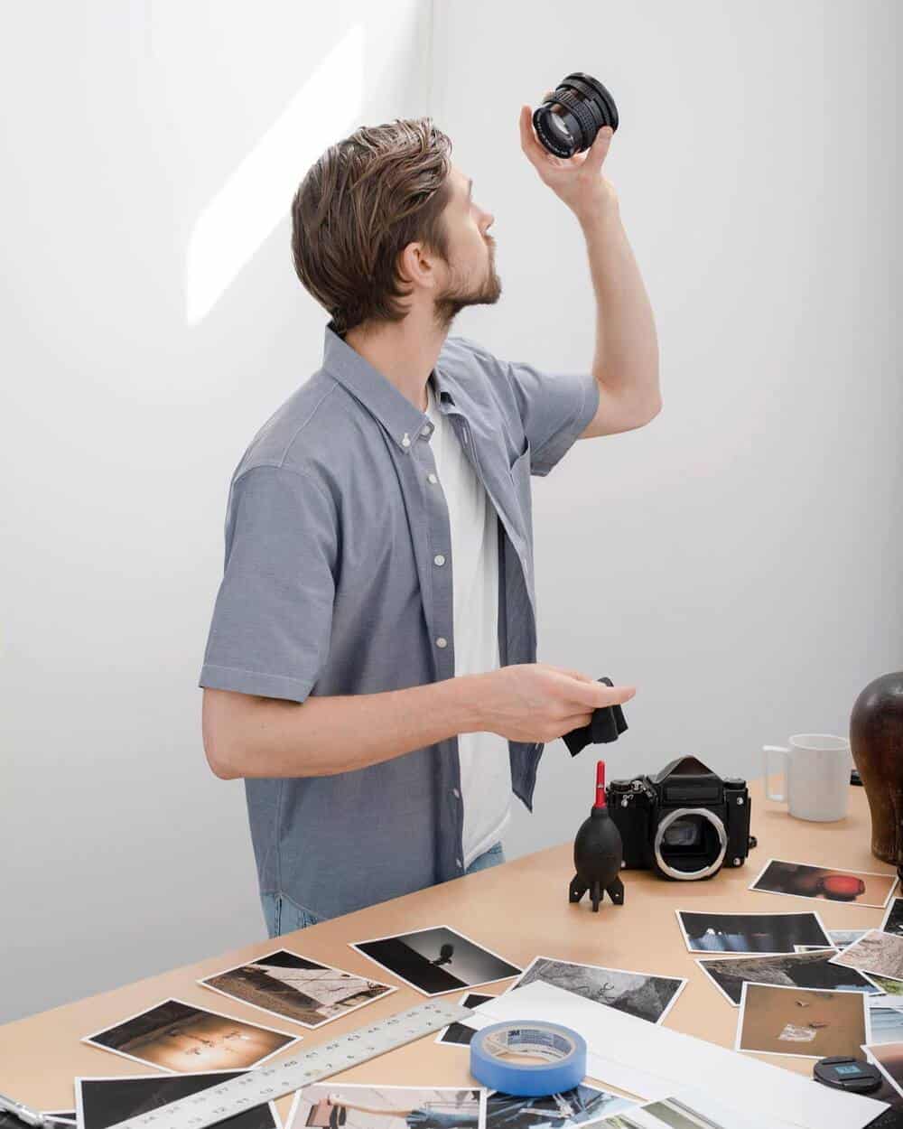 man checking a camera lens