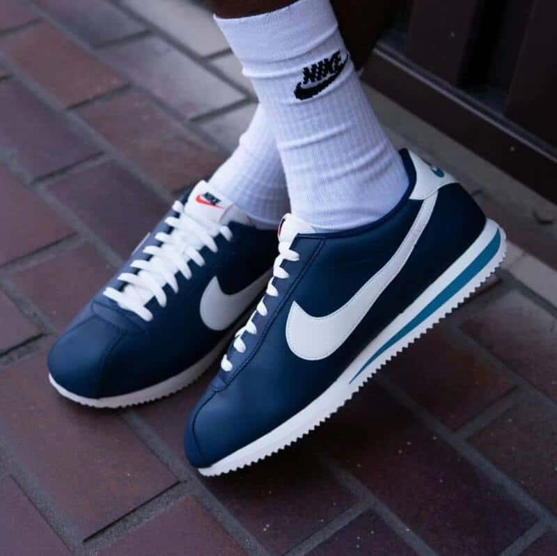 a pair of blue Nike Cortez with white soles