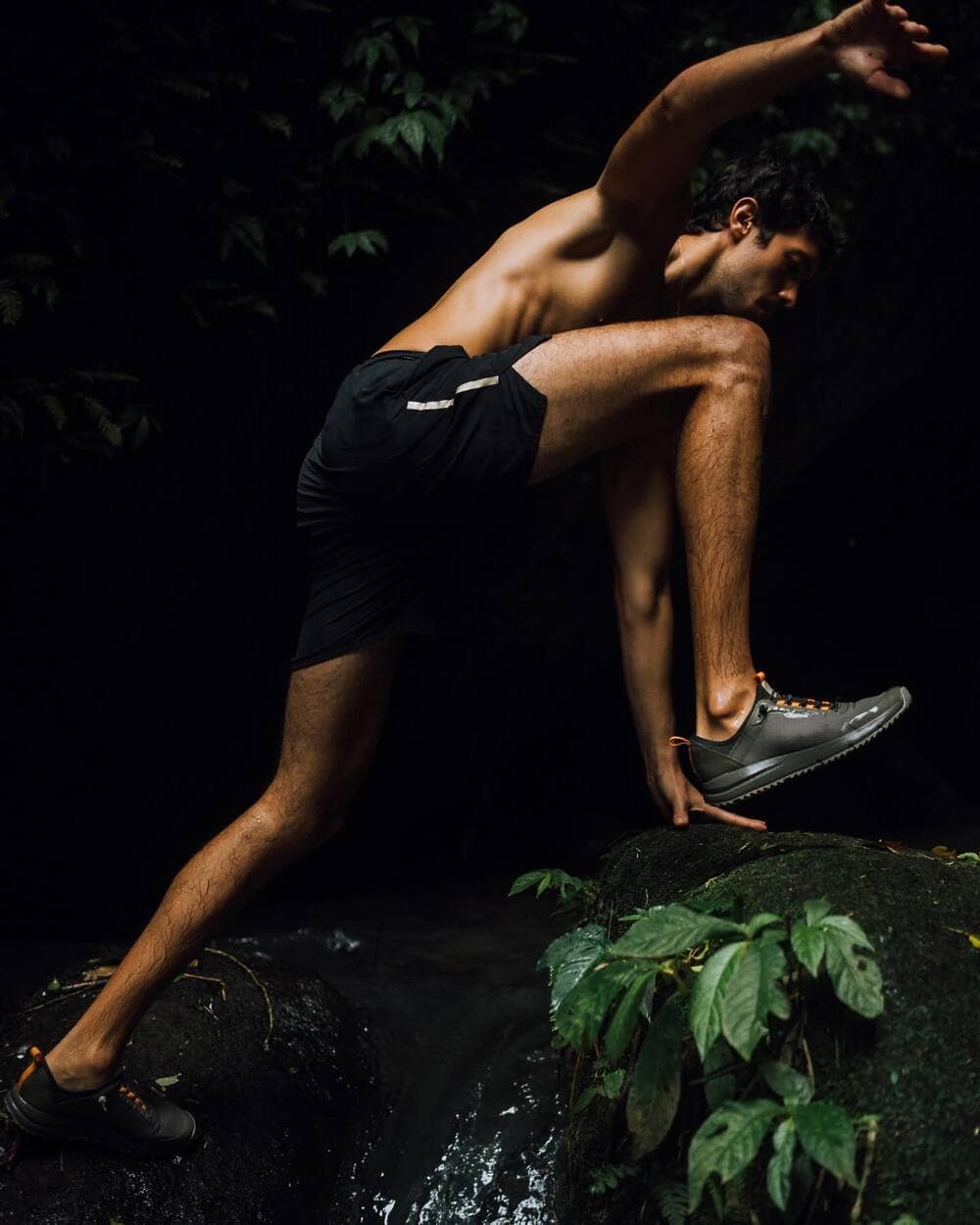 man wearing the All-Terrain by Tropicfeel moving from rock to rock