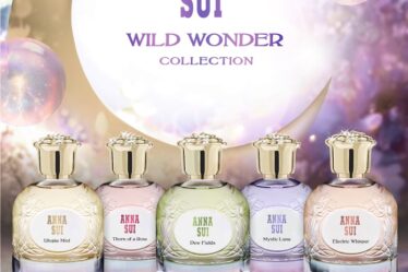 The five Anna Sui Wild Wonder fragrances sit on an open book in front of bubbles and a crescent moon.