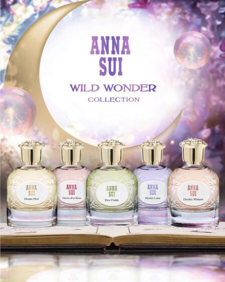 The five Anna Sui Wild Wonder fragrances sit on an open book in front of bubbles and a crescent moon.