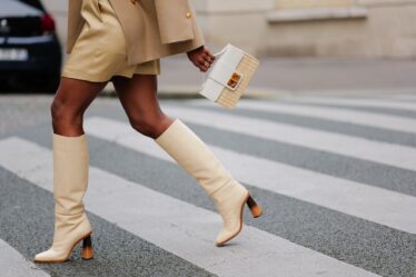 Best knee-high boots _ woman walking wearing cream knee-high boots