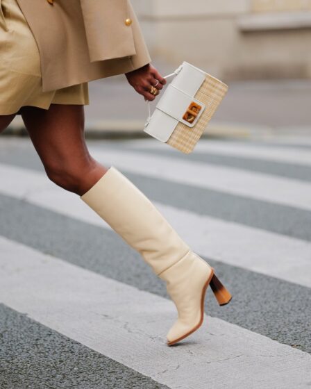 Best knee-high boots _ woman walking wearing cream knee-high boots