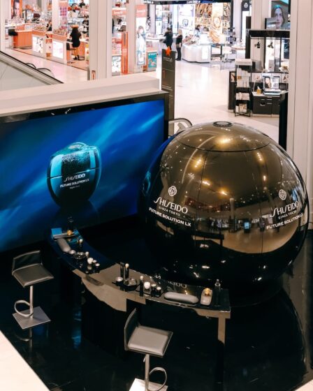 In the middle of the 34th street Macy's store's beauty floor is a car-sized orb wrapped in black and gold Shiseido branding, flanked by makeup counters.