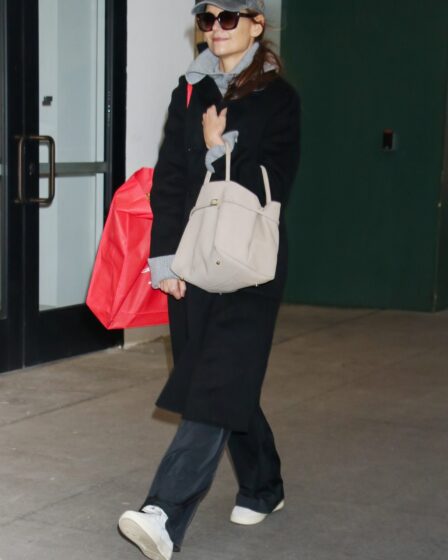 Image may contain Katie Holmes Accessories Bag Handbag Clothing Footwear Shoe Coat Hat Person Walking and Glasses