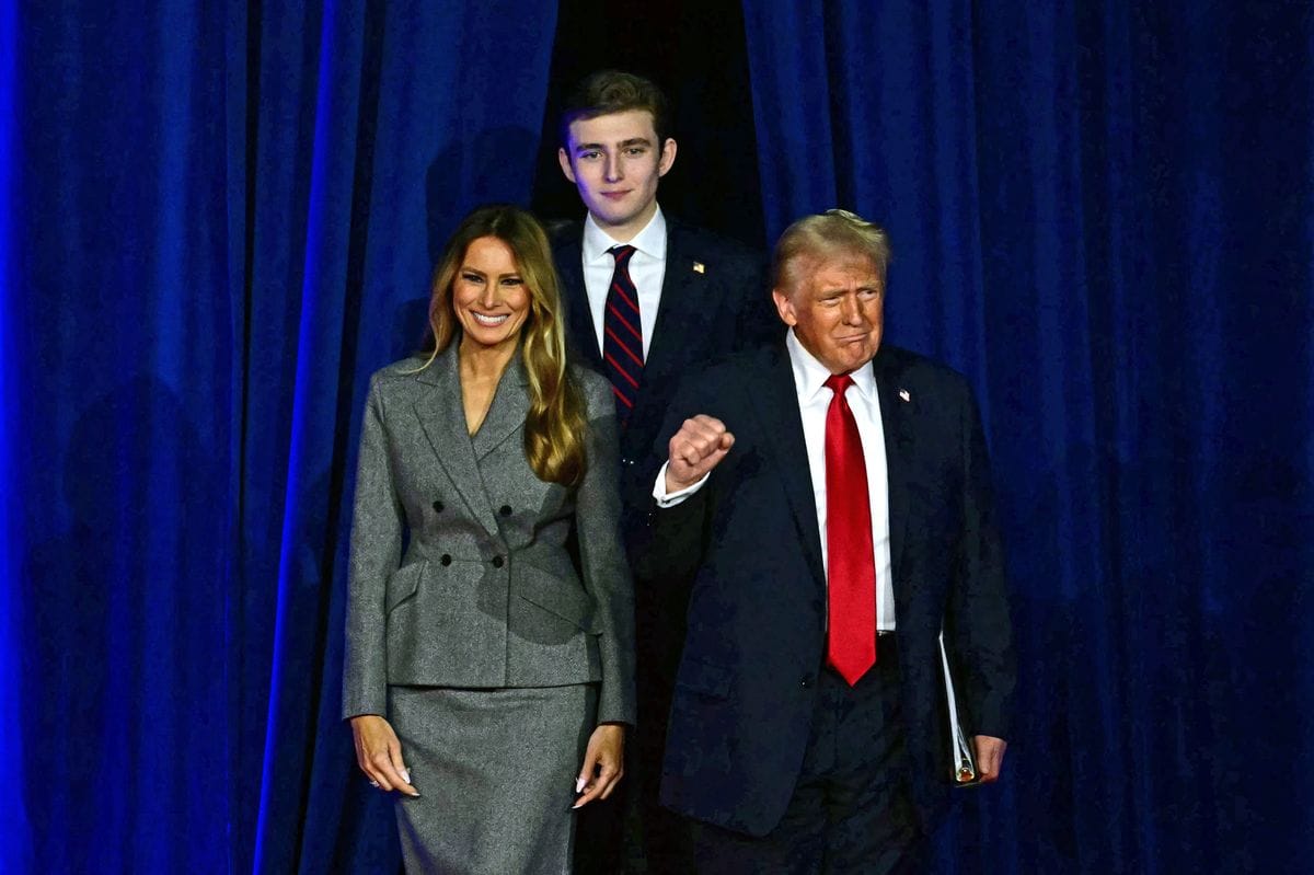 Donald Trump arrives for an election night event alongside Melania Trump and his son Barron Trump