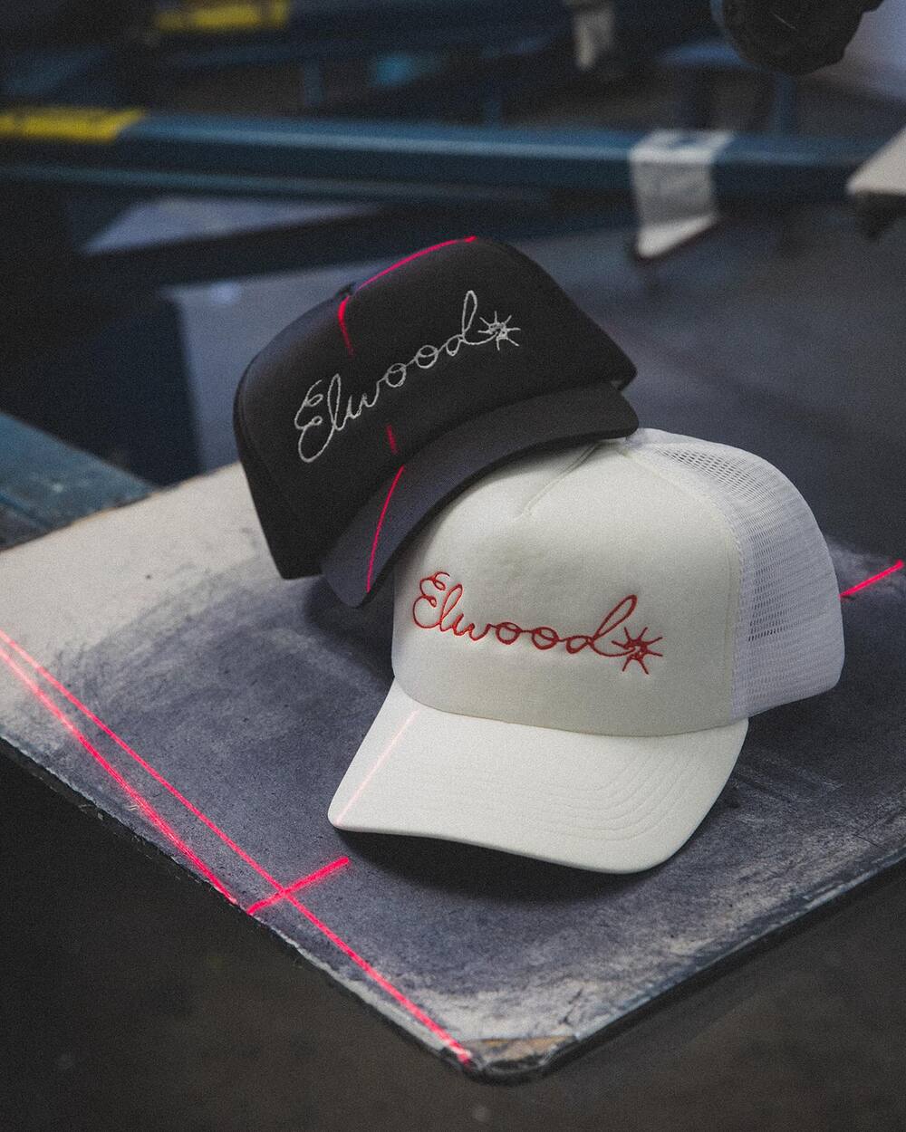 a black and a white trucker hat by Elwood