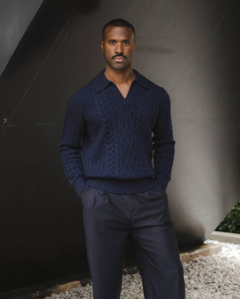 man wearing a v-neck cable knit sweater by Banana Republic