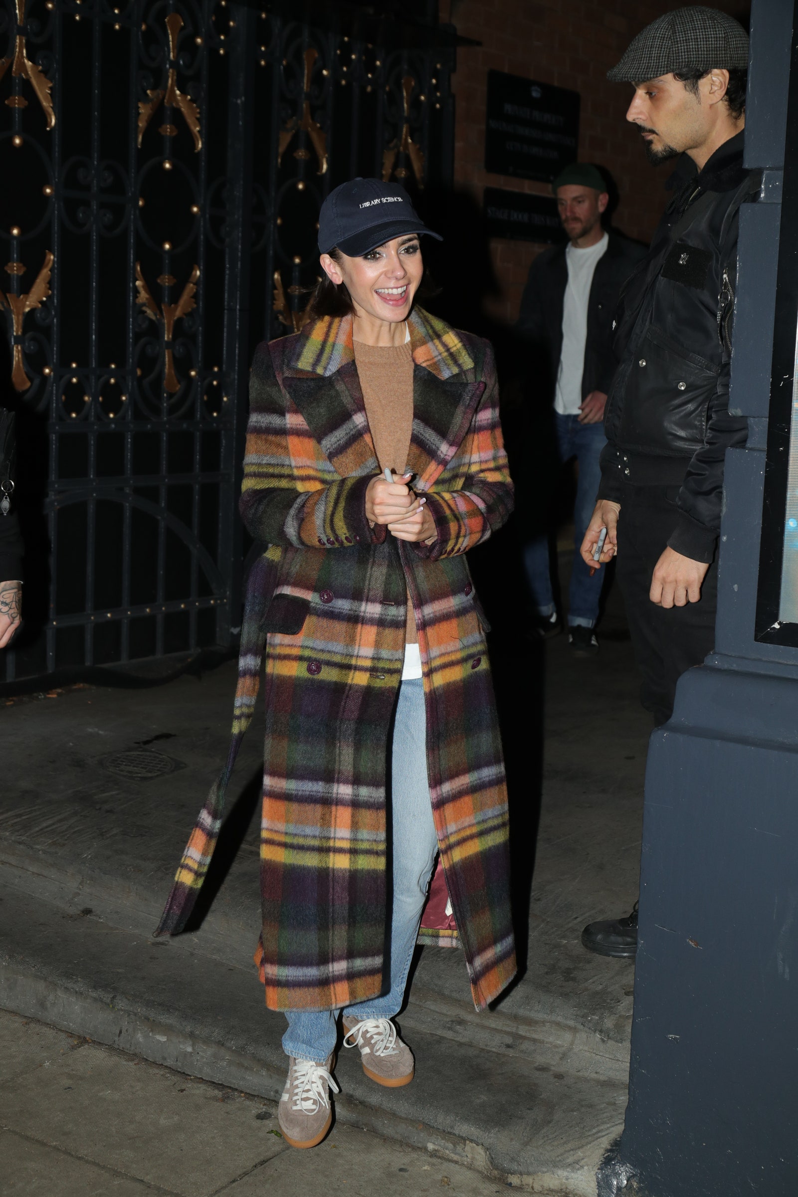 Image may contain Lily Collins Charlie McDowell Clothing Coat Footwear Shoe Hat Person Adult Tartan and Overcoat